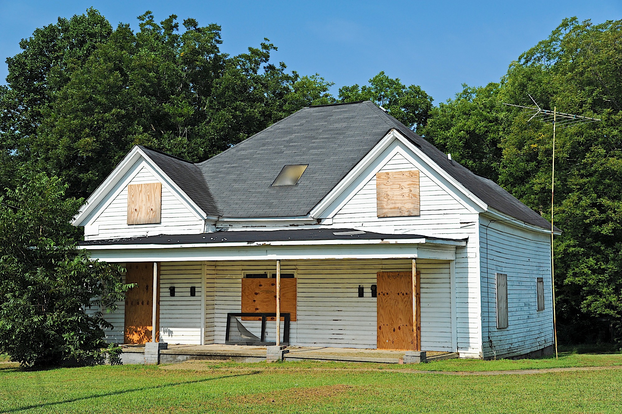 Abandoned House with Boarded up Windows and Doors